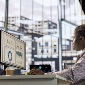 African american manager analyzing company data for strategic planning, solving resource allocation and effective business operations. Expert does financial forecasting and data analysis.